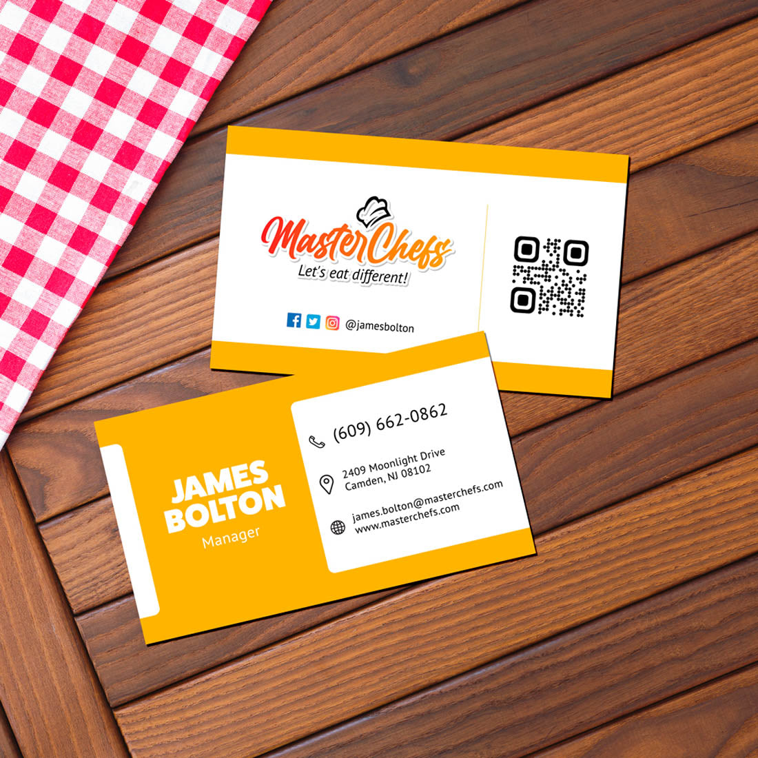 Restaurant branding business cards for MasterChefs displayed on wooden table with checkered cloth