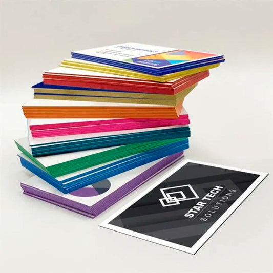 Stack of thick business cards with colorful painted edges and premium print designs
