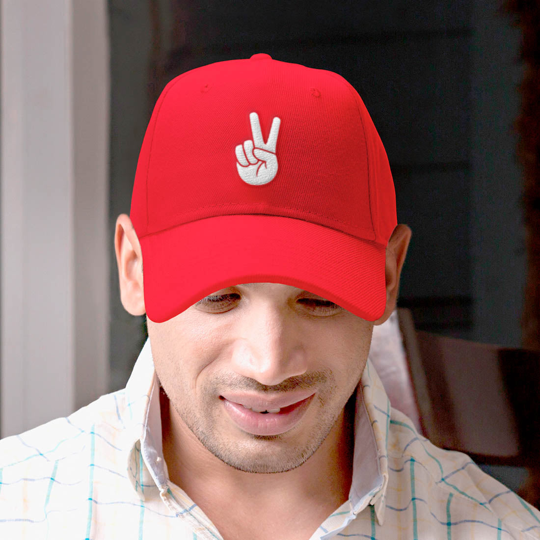 Red embroidered baseball cap with peace hand sign logo