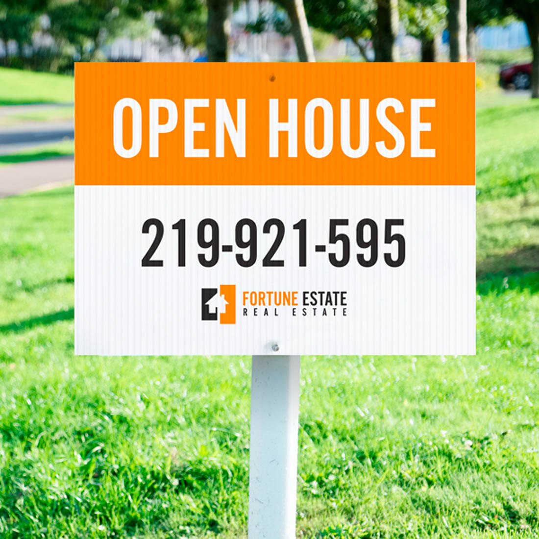 Corrugated yard sign displaying Open House message with phone number and real estate logo