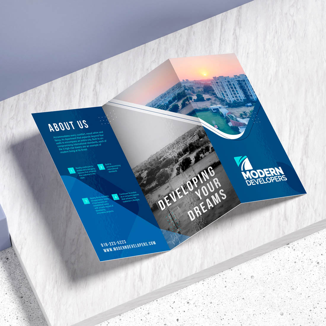 Modern Developers tri-fold brochure with blue design and Developing Your Dreams messaging
