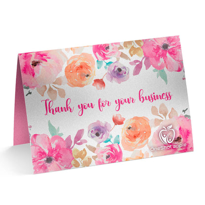 Folded thank you card with watercolor floral border and handwritten-style message